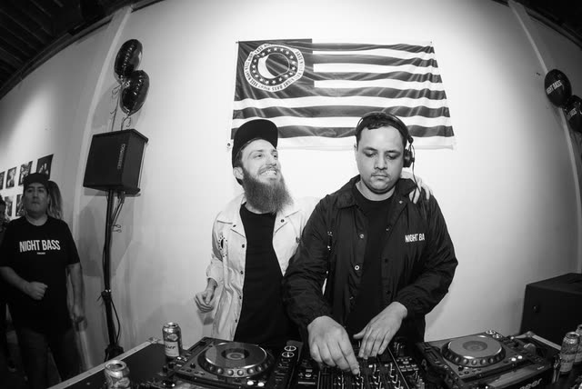 Black and white shot of the booth at a Night Bass show